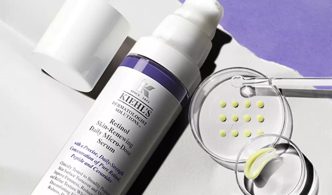 Bottle of Kiehl's Retinol Serum with a Petri dish with formula samples in the background